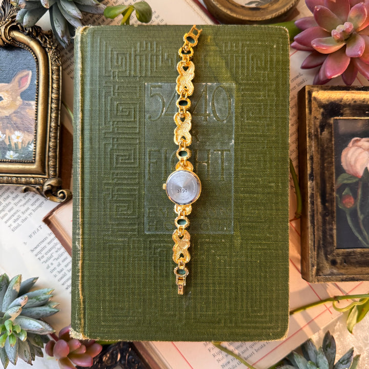 Gold Watch with Red and Green Stones